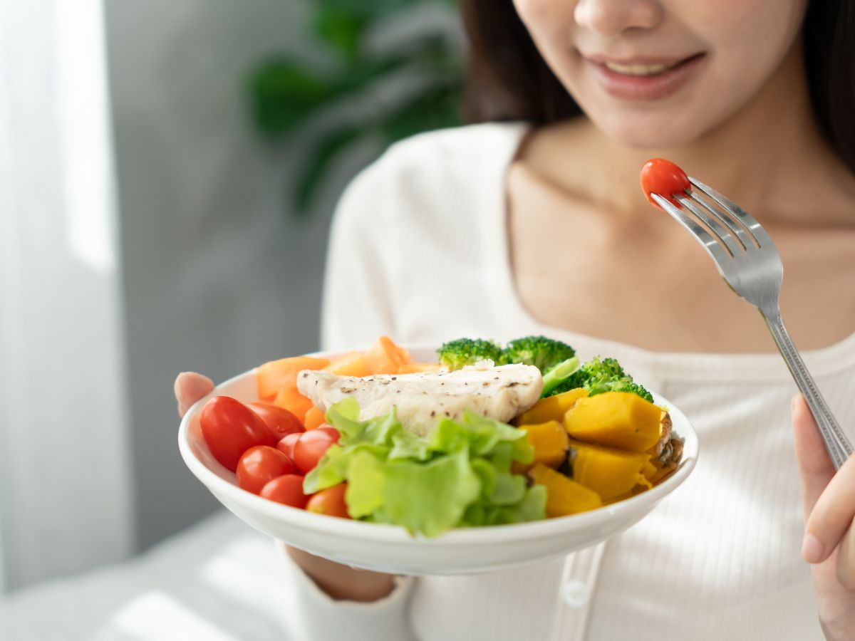 A simple, colorful plate of whole foods, representing balanced nutrition and wellbeing